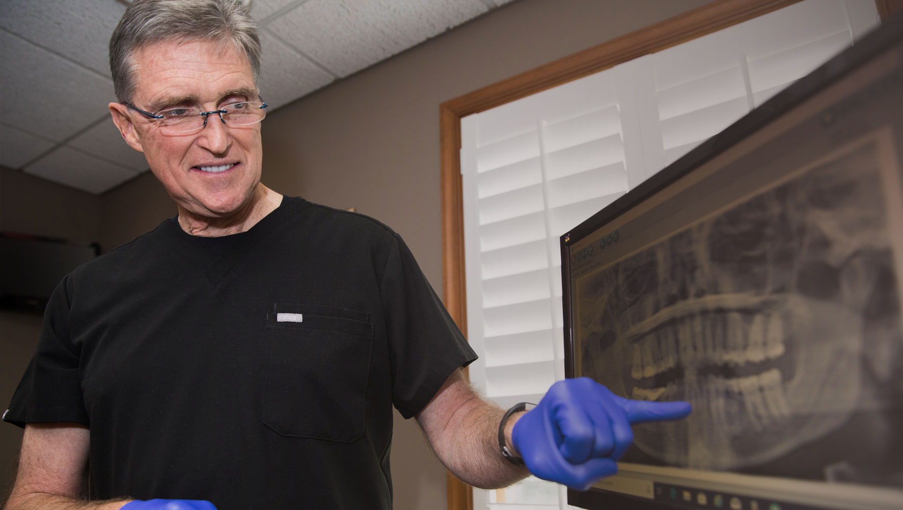 drbanksgoingoverthedentalxrayswithpatient Smile Designs of